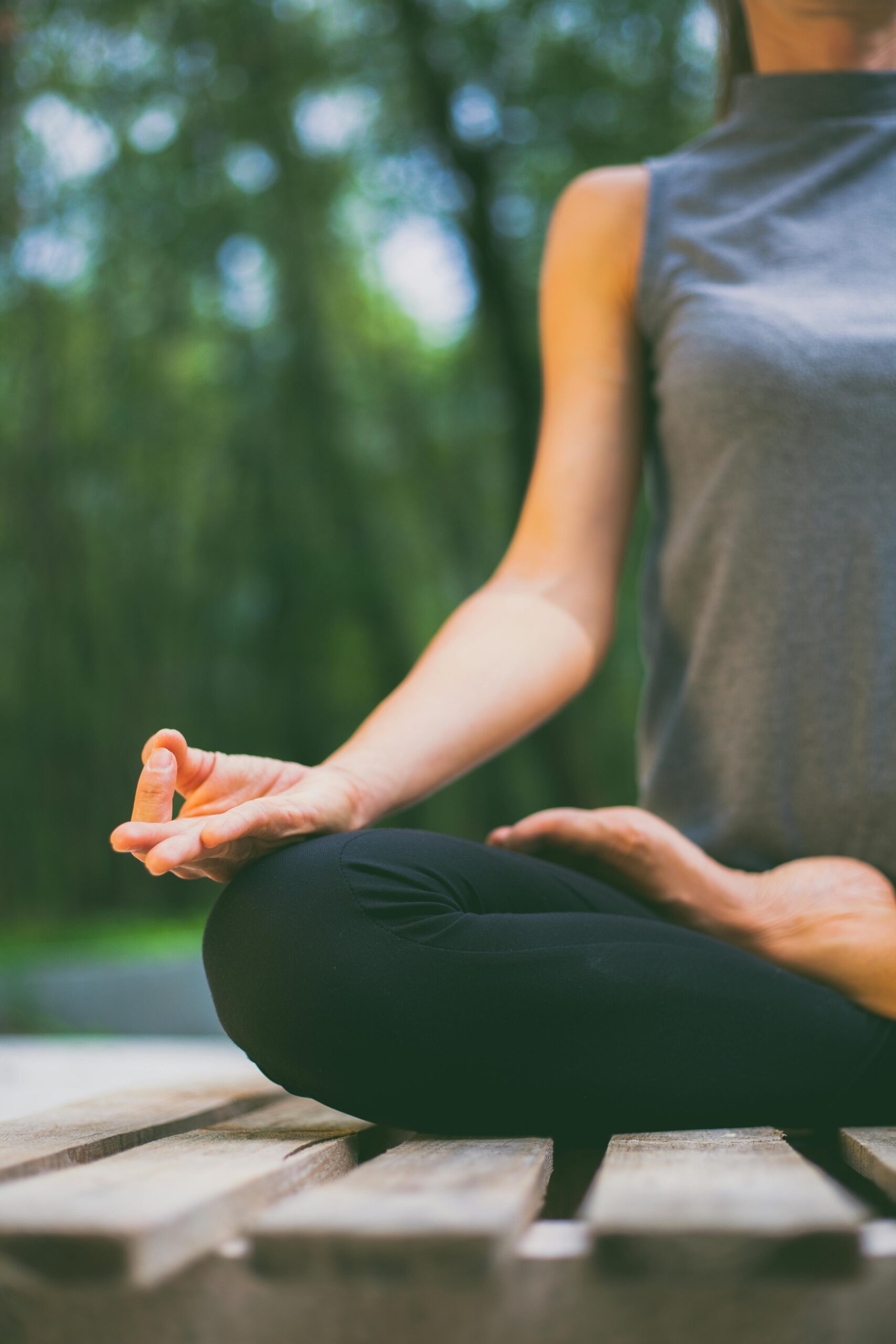 A person practicing meditation outdoors, focusing on mindfulness and relaxation.