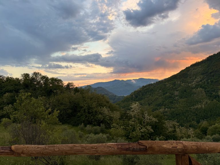 Dramatic sunset over the Tuscan mountains with orange and pink clouds
