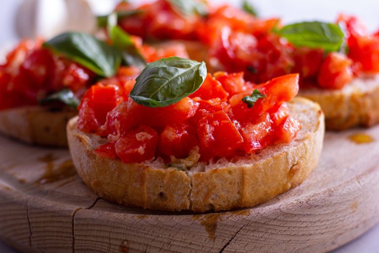 Close-up of tomato and basil bruschetta on toasted bread served at a Tuscany wellness retreat