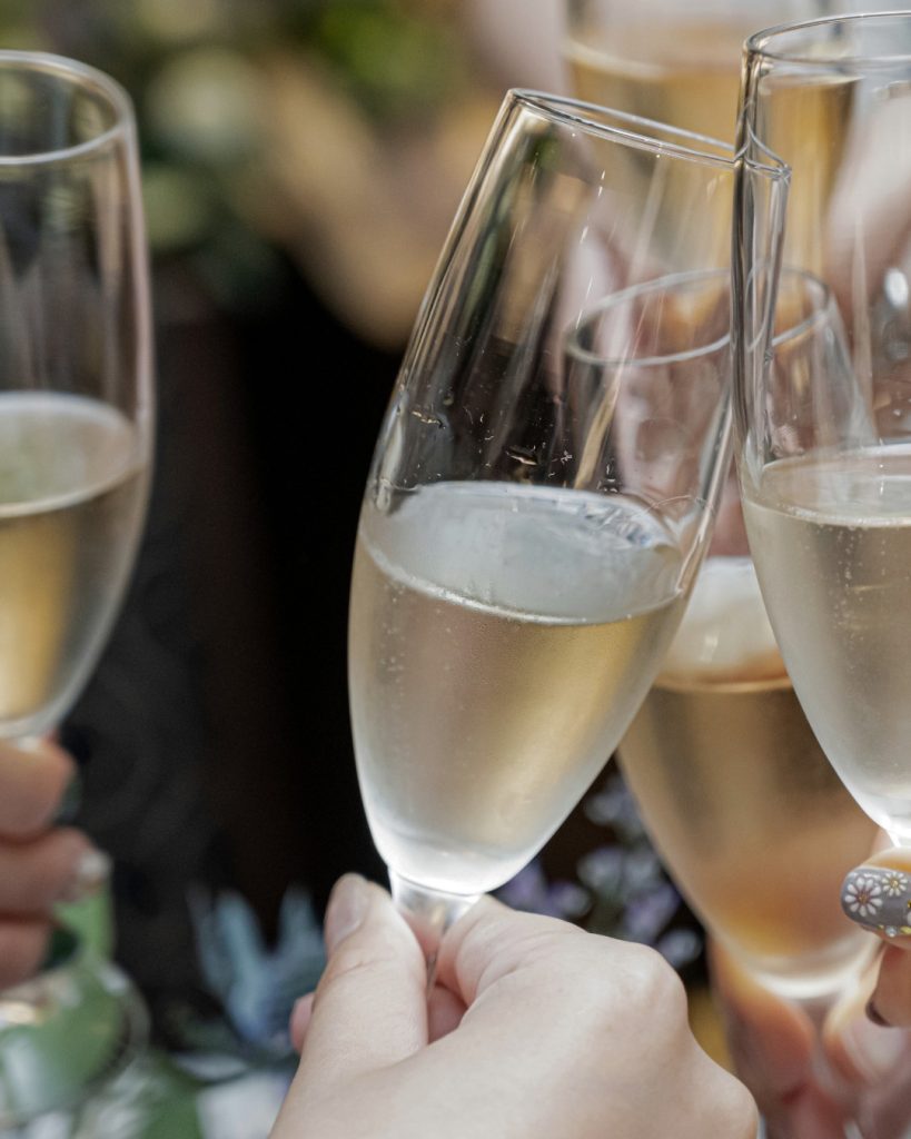 Friends raising glasses of sparkling wine in a toast to celebrate a milestone birthday in Tuscany